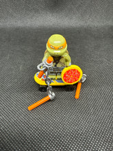 Load image into Gallery viewer, Brand New Vintage Michelangelo TMNT Mini Custom Lego with Nun chucks and Skateboard and Pizza
